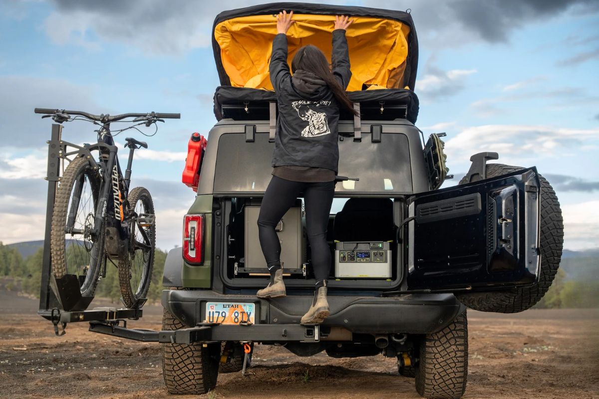 Open tailgate of Ford Bronco with swing-out bike carrier and overland gear