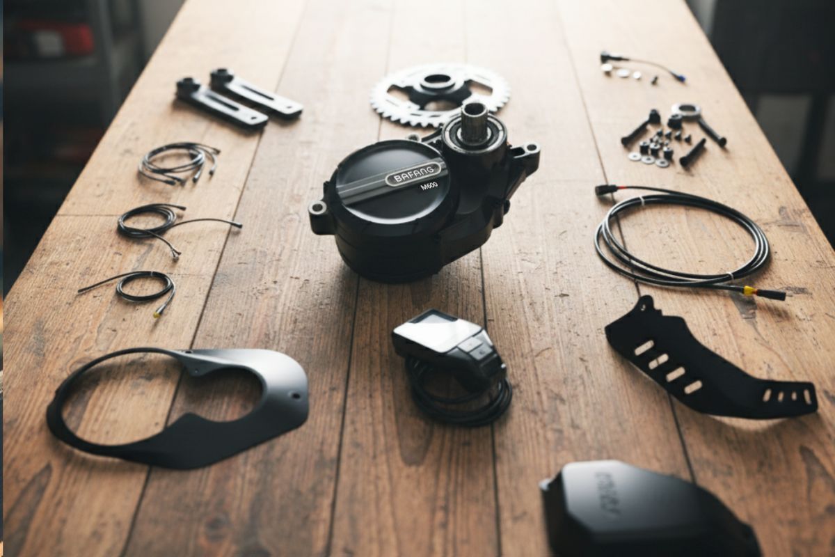 Bafang M600 e-bike conversion kit with motor, display and wiring laid out on table after unboxing